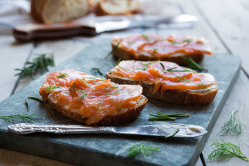 Sandwithes with smoked salmon and creamy cheese on bread