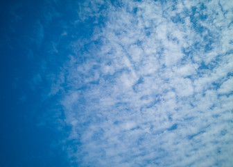Fototapeta na wymiar Beautiful white cirrus clouds on a blue sky. Autumn sky and good weather. Background..
