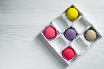 Box with macarons cookies isolated on white background.