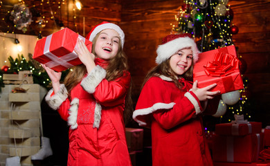 Best wishes. Little girl sisters in red hats. We are family. Elf children. Xmas present. Santa claus little girls sisters. Christmas time. Family holiday. Happy sisters. Happy new year. Family party