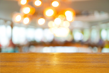 Empty wooden table top with blurred of restaurant cafe background, can be used for display or montage your products