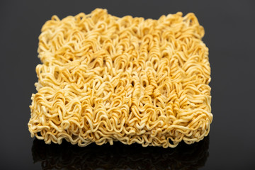 Raw instant noodle ready to cook isolated on black background