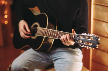 the guy plays the guitar. close-up of hands