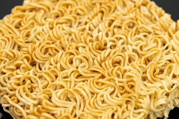 Raw instant noodle ready to cook isolated on black background