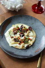 Healthy homemade flatbread with hummus and olives