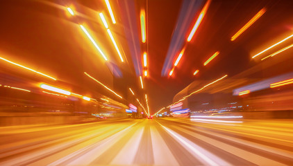 City colorful night lights perspective blurred by high speed of the car. A streak of light, trails.