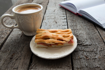 Apple pie with cup of coffee on table