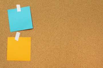 Sticky and pin blank paper notes on cork board to remind.