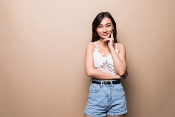 Asian happy smiling woman isolated on beige background