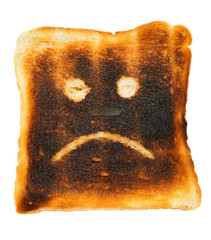 Unhappy smiley burnt slice of toast bread. Signs symbol mad mood on slice of roasted bread. P