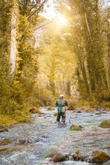 Obraz premium Man fishing a river