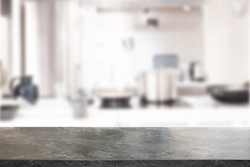 Black Marble Stone table top and blurred kitchen interior background with white light filter - can...