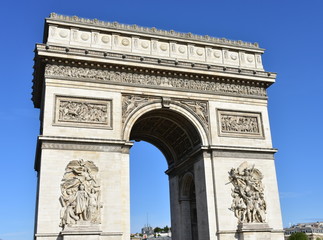 View of Arc de Triomphe from Champs Elysees with blue sky. Paris, France.