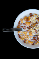 Variety of cold cereals in white bowls, quick breakfast for kids overhead shot with copyspace