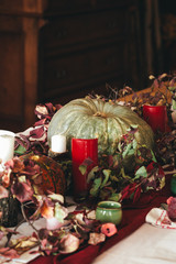 Fall thanksgiving decor with candle and pumpkins close up