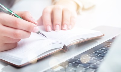 Fototapeta premium Woman with Laptop and Paperwork on background