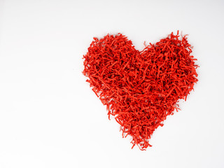Plakat symbol of love or separation. heart of cut red paper, with crumbling and disintegrating red heart, shredder paper, wrapping paper. copy space. concept of Valentine's day, lheart on white background. c