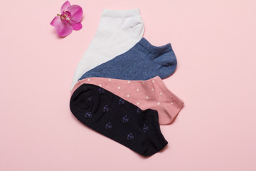 Women socks on pink background. Top view.