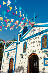 Church Chapel Sao Joao Batista, in Ilhabela, north coast of Sao Paulo, Brazil, decorated with typical party celebration Junina flags.