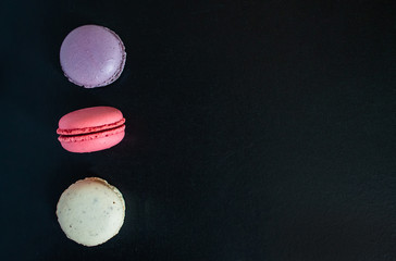 Macaroons cookies on a dark canvas background. view from above.