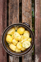 pan of boiled young potatoes with dill