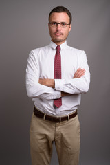 Portrait of handsome businessman against gray background