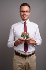 Portrait of handsome businessman against gray background