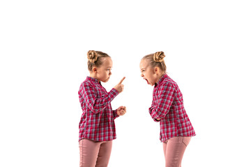Young handsome girl arguing with herself on white studio background. Concept of human emotions,...