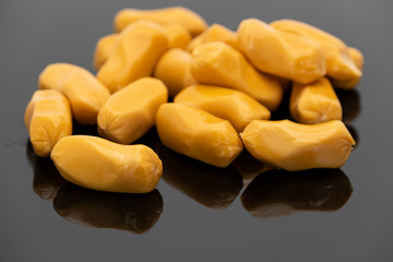 Pile of raw sausages isolated on black background with shadow