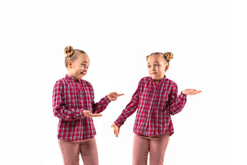 Young handsome girl arguing with herself on white studio background. Concept of human emotions,...