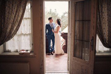 Bride and groom posing at country side