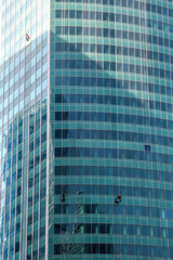 Сlimbers wash windows and glass facade of the skyscraper. Moscow city (Moscow International Business Center) , Russia