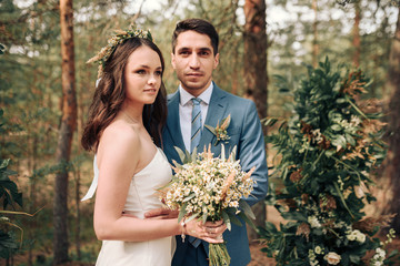 Bride and groom posing at country side