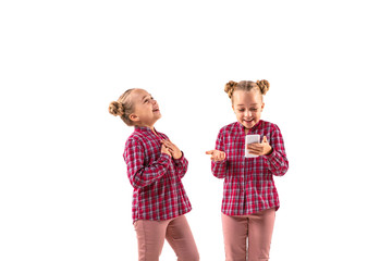 Young handsome girl arguing with herself on white studio background. Concept of human emotions,...