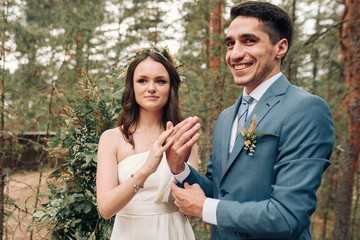 Bride and groom posing at country side