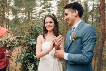 Bride and groom posing at country side