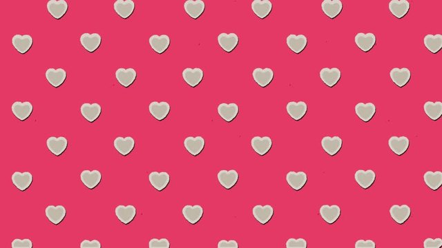 A catchy animation: a white heart (repeating pattern, floating towards the upper left angle of the screen), over a red background.
