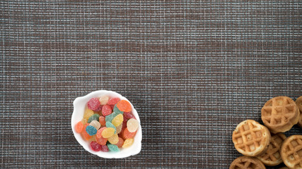 wafers and monpassier sweets on a table on a dark background flatlay