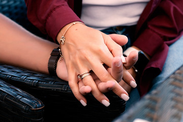 guy holds girl's hand, closeup