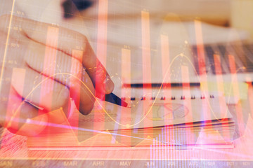 Multi exposure closeup hands with stock market forex graph.