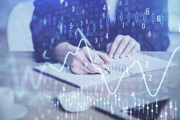 Forex graph on hand taking notes background. Concept of research. Multi exposure