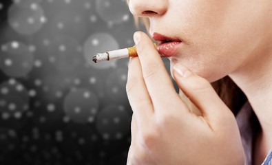 Fototapeta premium Portrait of the young elegant girl smoking cigarette isolated