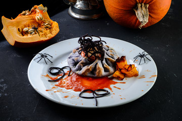 Traditional autumn dishes. Halloween, Thanksgiving. Spicy pumpkin dish decorated with spiders for halloween table