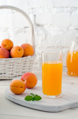 Glass with apricot juice and apricot fruit