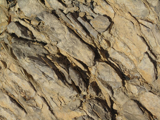 Light brown rock texture. Abstract stone background. Rock grunge backdrop. Part of the mountain close-up.