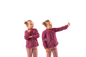 Young handsome girl arguing with herself on white studio background. Concept of human emotions,...