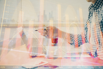 Obraz premium Multi exposure of stock market chart with man working on computer on background. Concept of financial analysis.