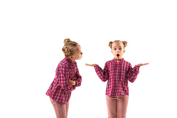 Young handsome girl arguing with herself on white studio background. Concept of human emotions,...