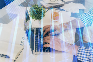 Multi exposure of graph with man typing on computer in office on background. Concept of hard work....