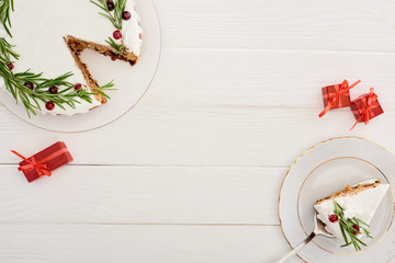 top view of christmas pie on white wooden table with little gifts